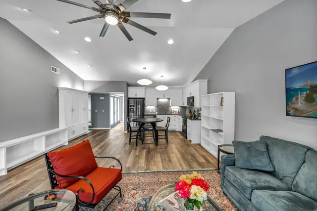 a living room with furniture and kitchen view