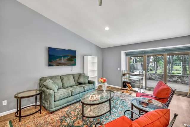 a living room with furniture and a floor to ceiling window