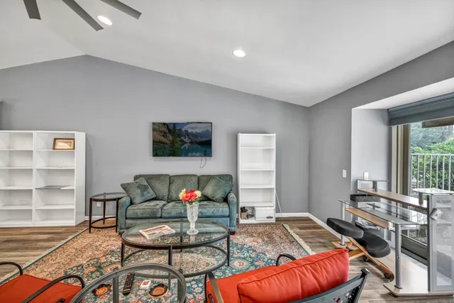 a living room with furniture a rug and a window