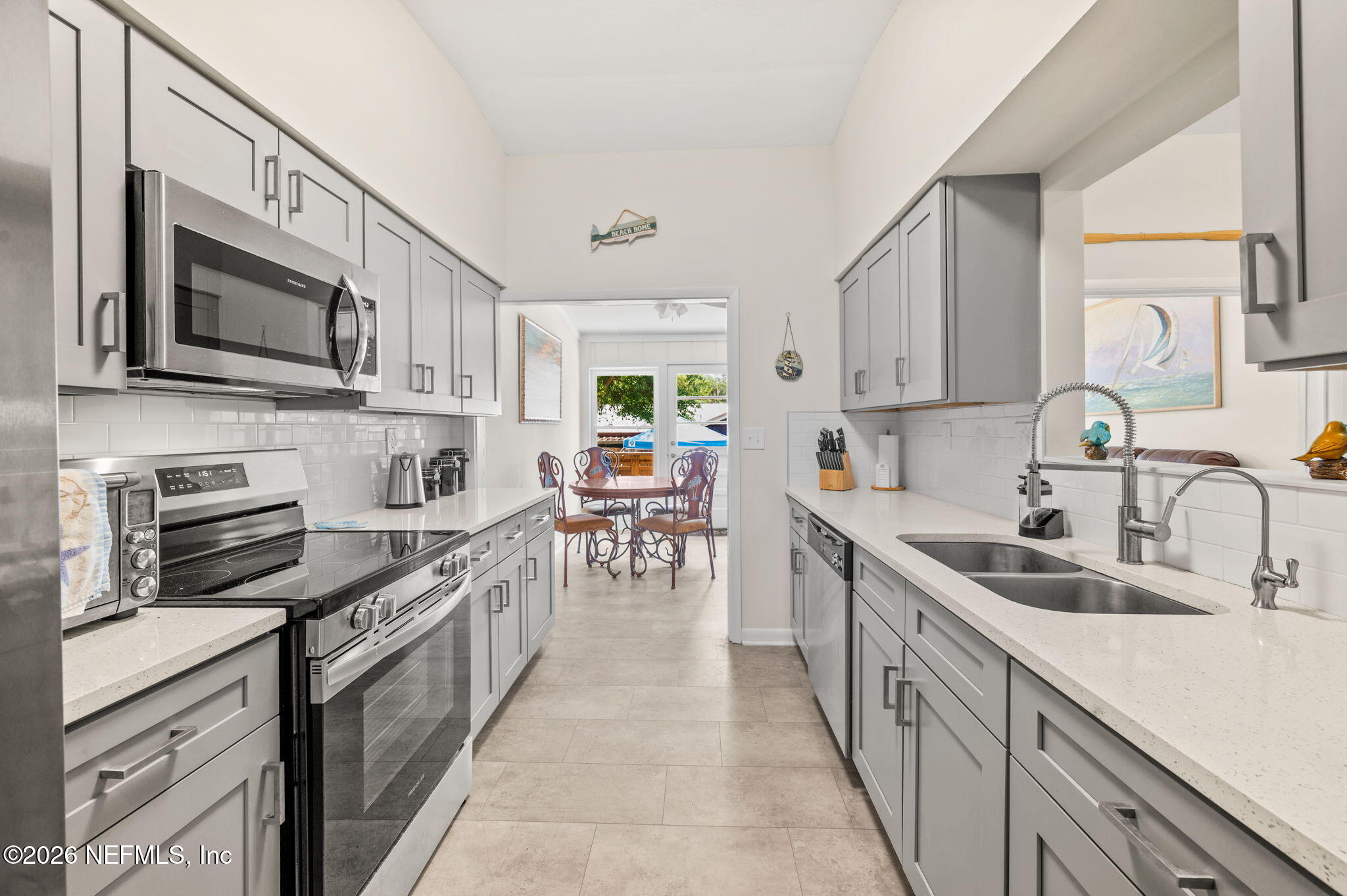 507 Gentian Road St. Augustine, FL 32086 - Photo 12 of 82 a kitchen with stainless steel appliances granite countertop a sink stove and refrigerator
