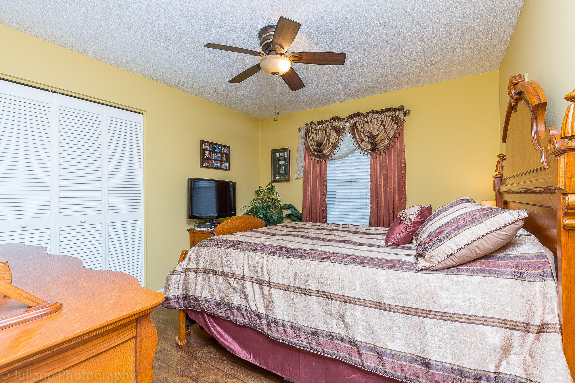 10880 Tea Olive Lane Boca Raton, FL 33498 - Photo 23 of 56 a bedroom with a bed and a chandelier