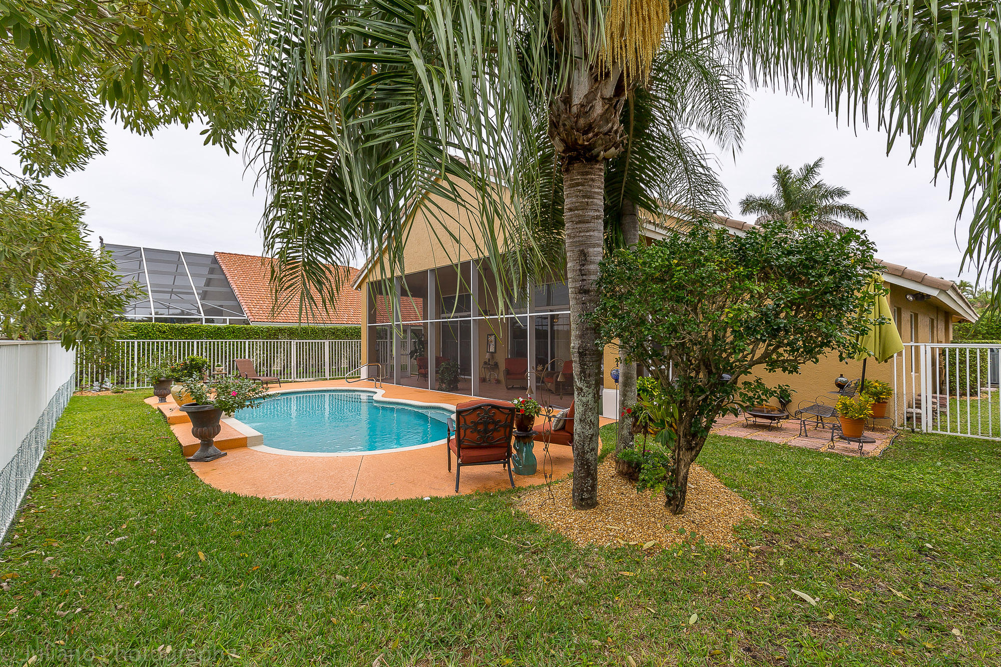 10880 Tea Olive Lane Boca Raton, FL 33498 - Photo 28 of 56 a view of a backyard with swimming pool