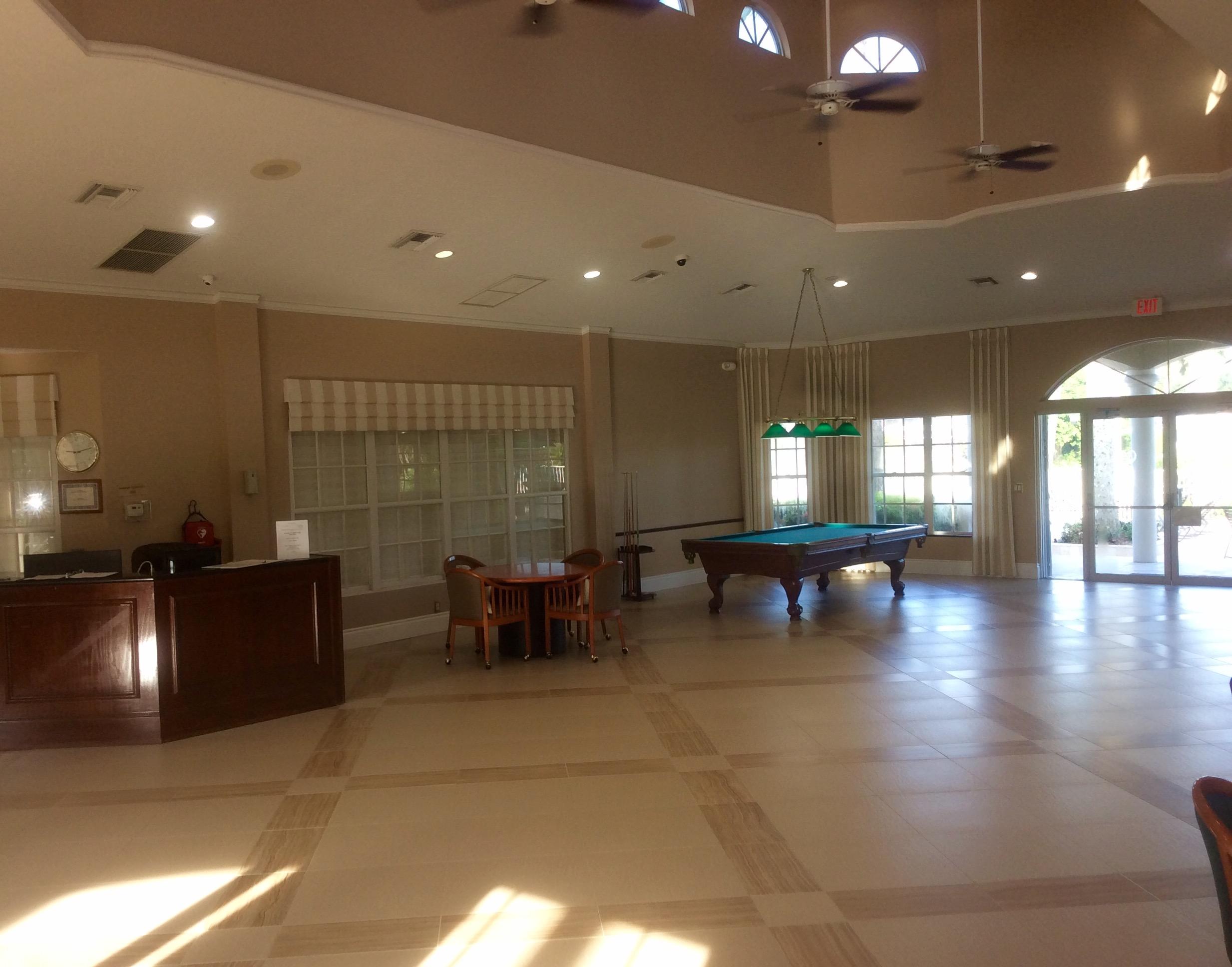 10880 Tea Olive Lane Boca Raton, FL 33498 - Photo 43 of 56 a lobby with furniture and tables