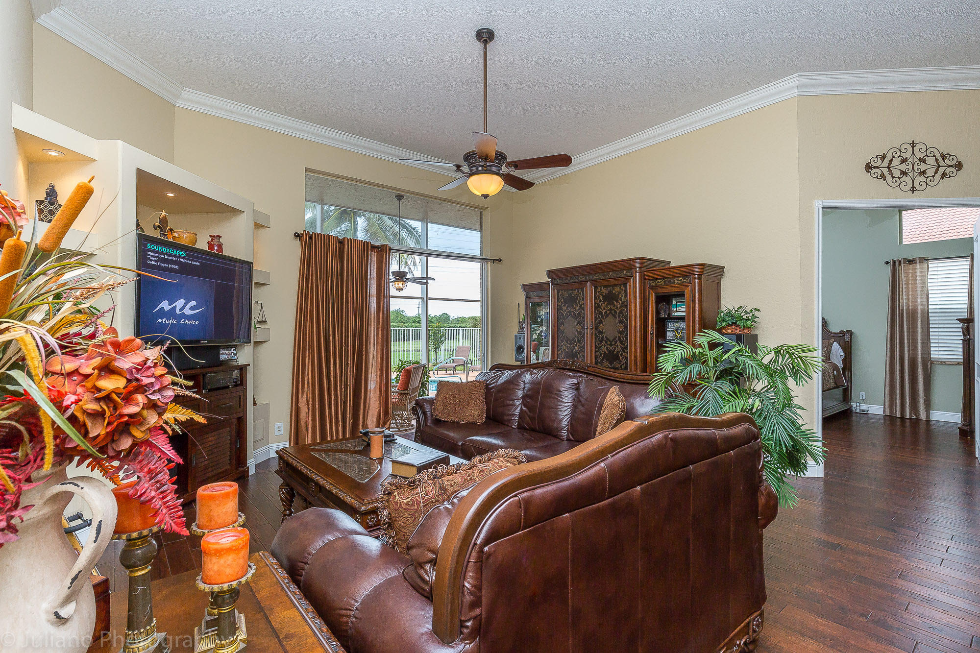 10880 Tea Olive Lane Boca Raton, FL 33498 - Photo 10 of 56 a living room with furniture a chandelier and a flat screen tv