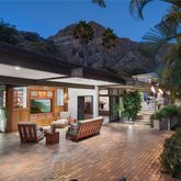 a view of a patio with furniture and garden