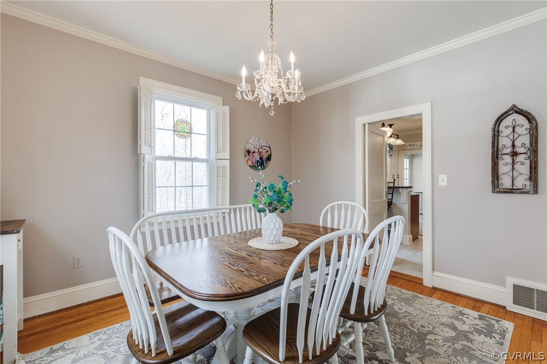 501 Old Hundred Road Midlothian, VA 23113 - Photo 19 of 44 a view of a dining room with furniture a chandelier and wooden floor