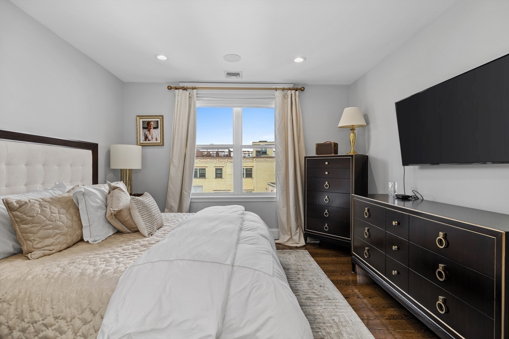 57 L Street, Unit 6 Boston, MA 02127 - Photo 12 of 21 a bedroom with a bed and a flat screen television
