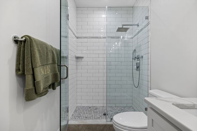 a bathroom with a shower toilet and sink