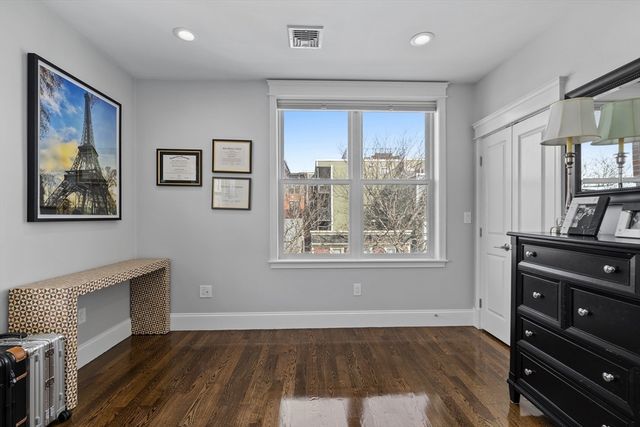 a view of room with window and wooden floor