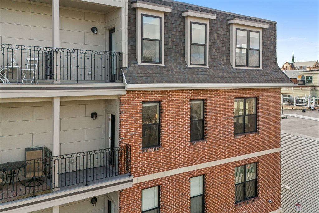57 L Street, Unit 6 Boston, MA 02127 - Photo 20 of 21 a view of a brick house with many windows