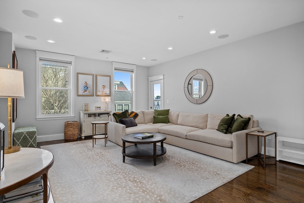 57 L Street, Unit 6 Boston, MA 02127 - Photo 8 of 21 a living room with furniture a clock on wall and a window