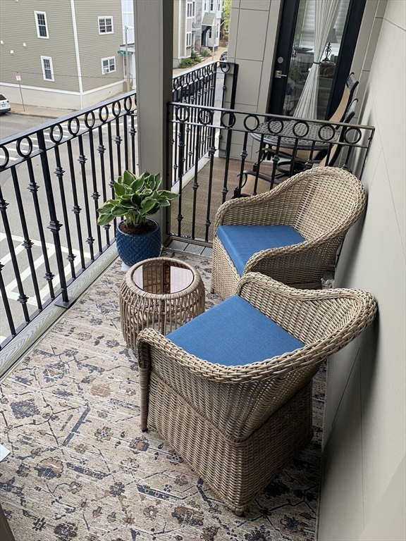 57 L Street, Unit 6 Boston, MA 02127 - Photo 10 of 21 a front view of a house with wooden floor chairs and outdoor seating