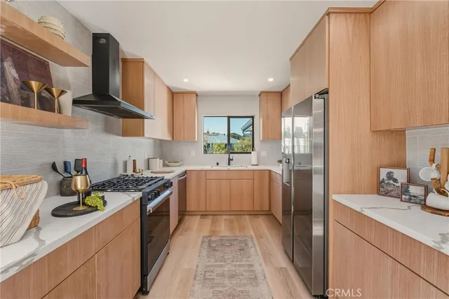 a kitchen with stainless steel appliances granite countertop a sink and a stove