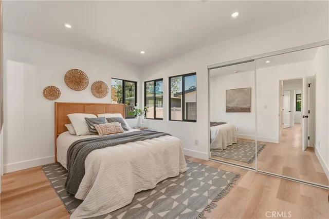 a bedroom with a bed and painting on the wall