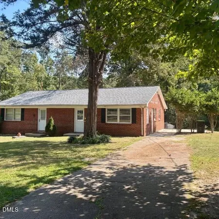 a house that has a tree in front of it