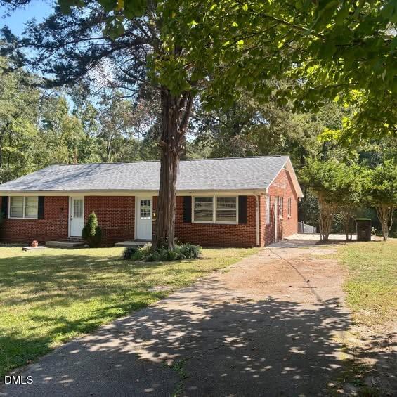 a house that has a tree in front of it