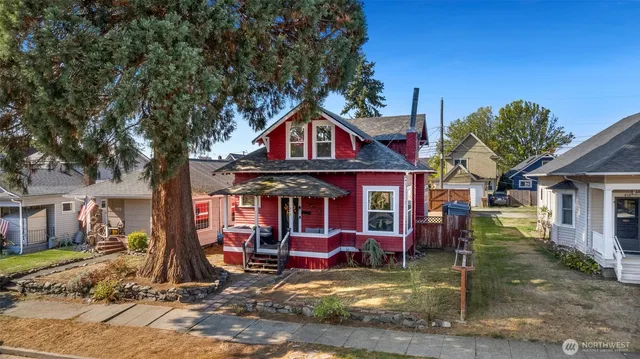 a view of a house with a yard balcony and sitting area