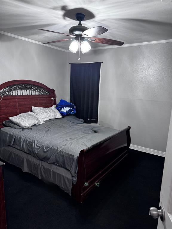 2906 West 9th Street Dallas, TX 75211 - Photo 3 of 7 a bedroom with a bed and a chandelier