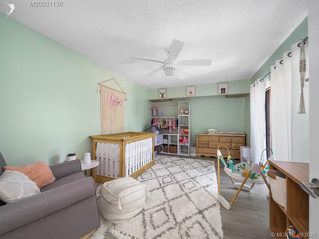5804 Southeast Windsong Lane Stuart, FL 34997 - Photo 11 of 20 a living room with furniture and a wooden floor