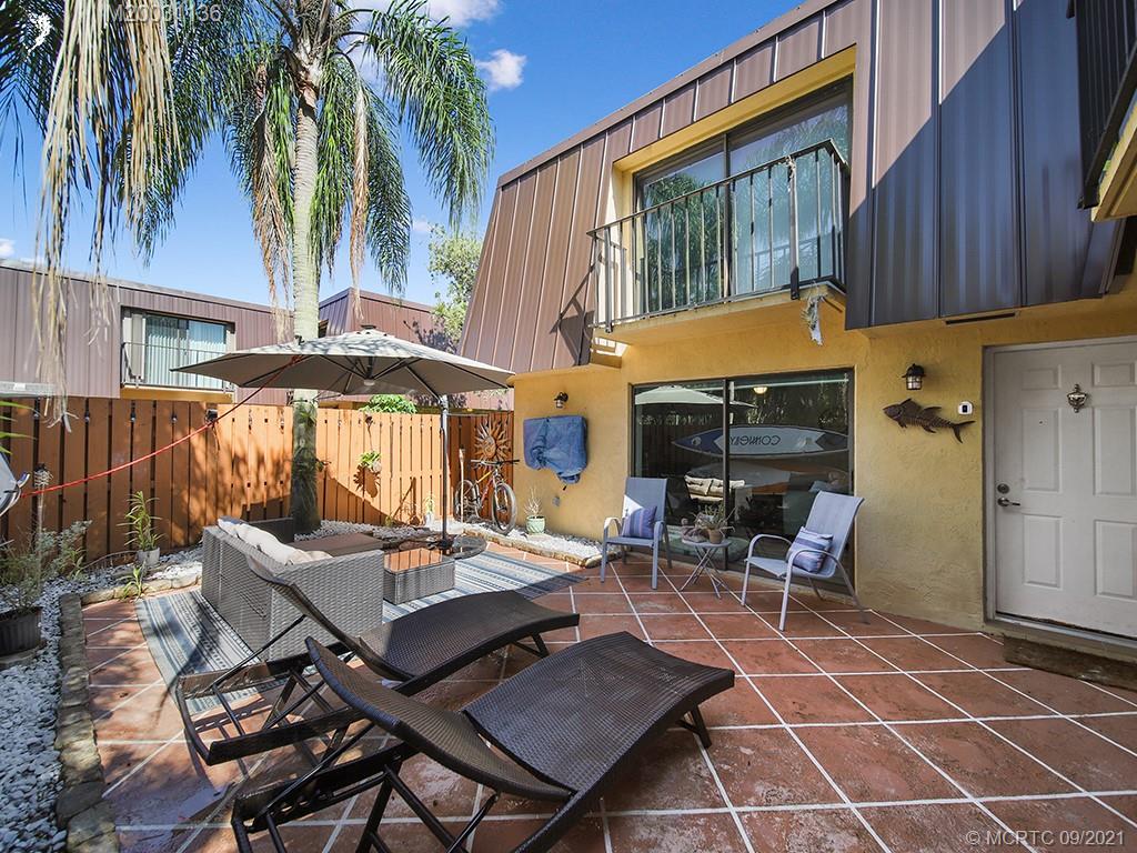 5804 Southeast Windsong Lane Stuart, FL 34997 - Photo 13 of 20 a backyard of a house with barbeque oven table and chairs
