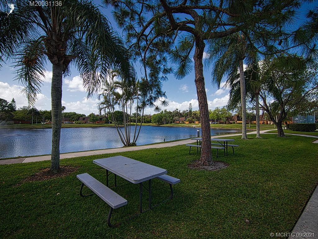 5804 Southeast Windsong Lane Stuart, FL 34997 - Photo 18 of 20 a view of a park with a palm tree