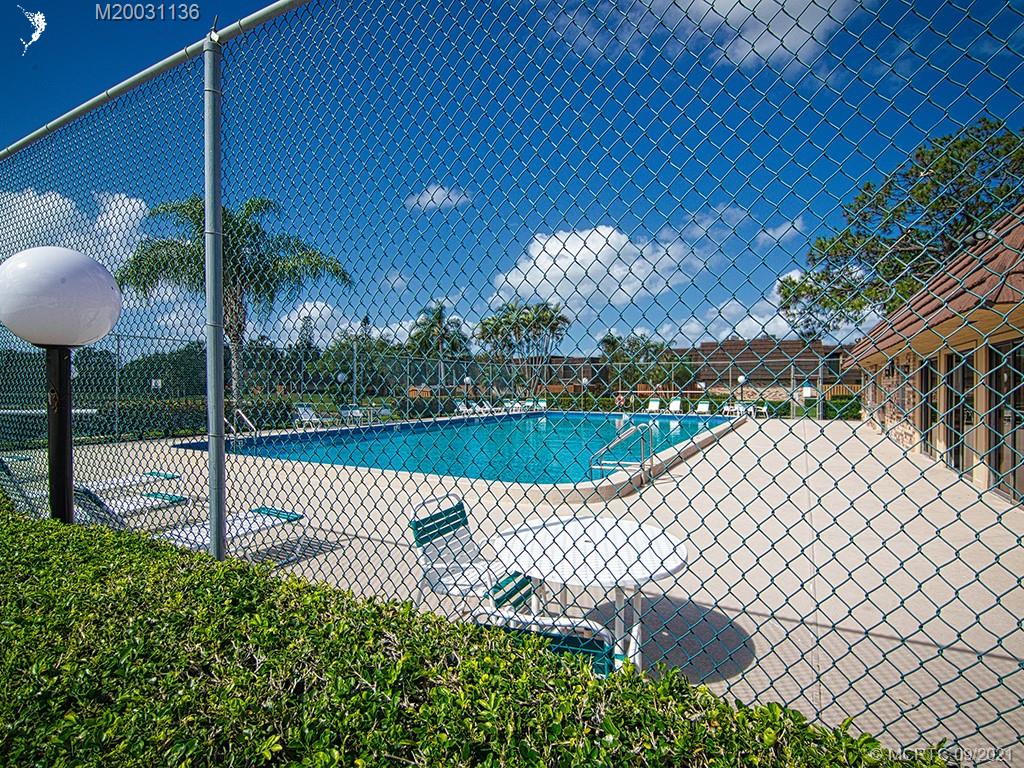 5804 Southeast Windsong Lane Stuart, FL 34997 - Photo 19 of 20 a view of a deck with a table and chairs