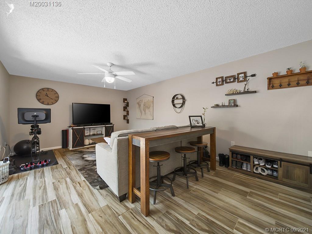 5804 Southeast Windsong Lane Stuart, FL 34997 - Photo 5 of 20 a view of a livingroom with furniture and a flat screen tv