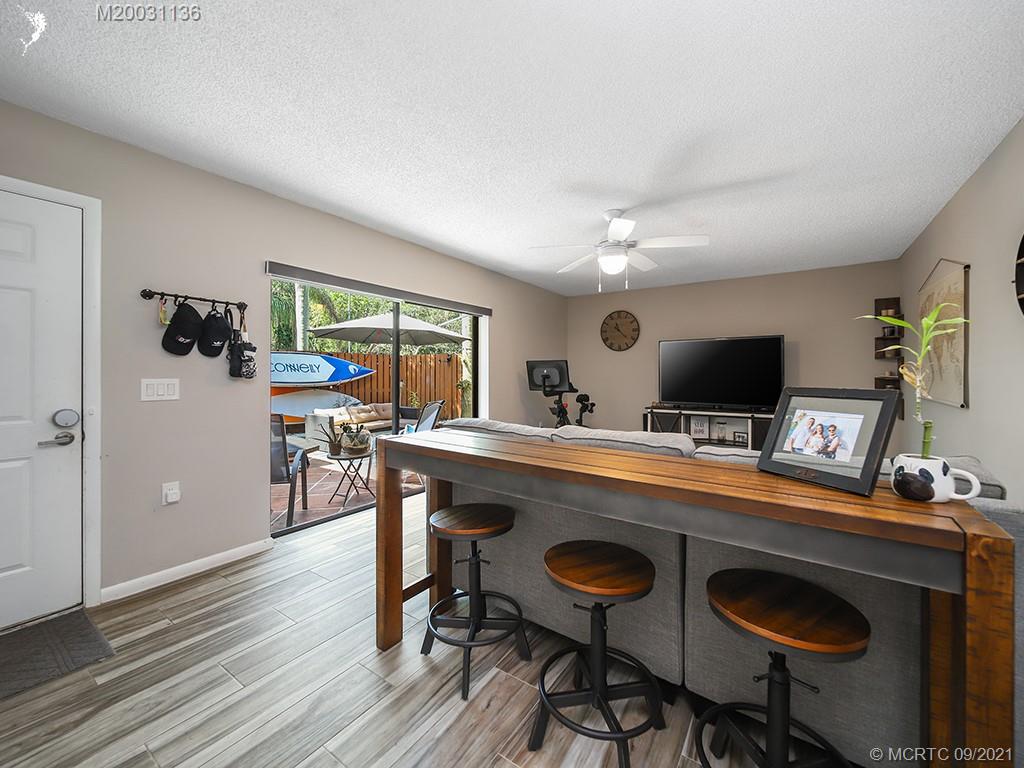 5804 Southeast Windsong Lane Stuart, FL 34997 - Photo 7 of 20 a workspace with furniture and wooden floor