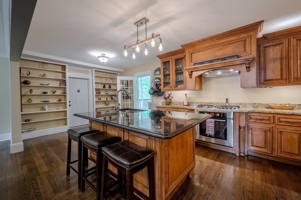 7 Argyle Street Worcester, MA 01609 - Photo 11 of 41 a kitchen with stainless steel appliances granite countertop a stove and a refrigerator