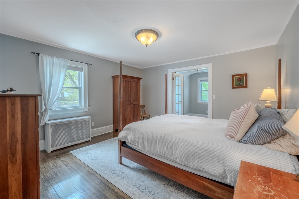 7 Argyle Street Worcester, MA 01609 - Photo 19 of 41 a bedroom with a bed and a refrigerator