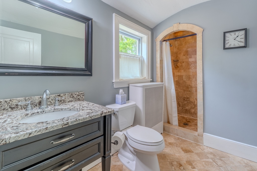 7 Argyle Street Worcester, MA 01609 - Photo 22 of 41 a bathroom with a granite countertop sink toilet and mirror