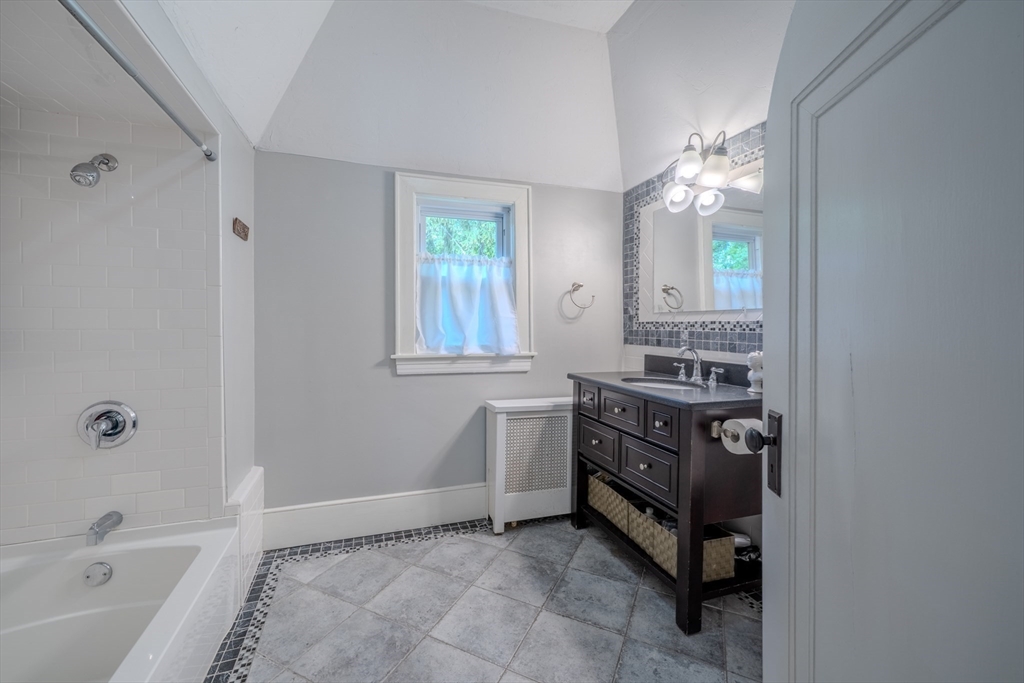 7 Argyle Street Worcester, MA 01609 - Photo 29 of 41 a bathroom with a sink a bathtub and a mirror