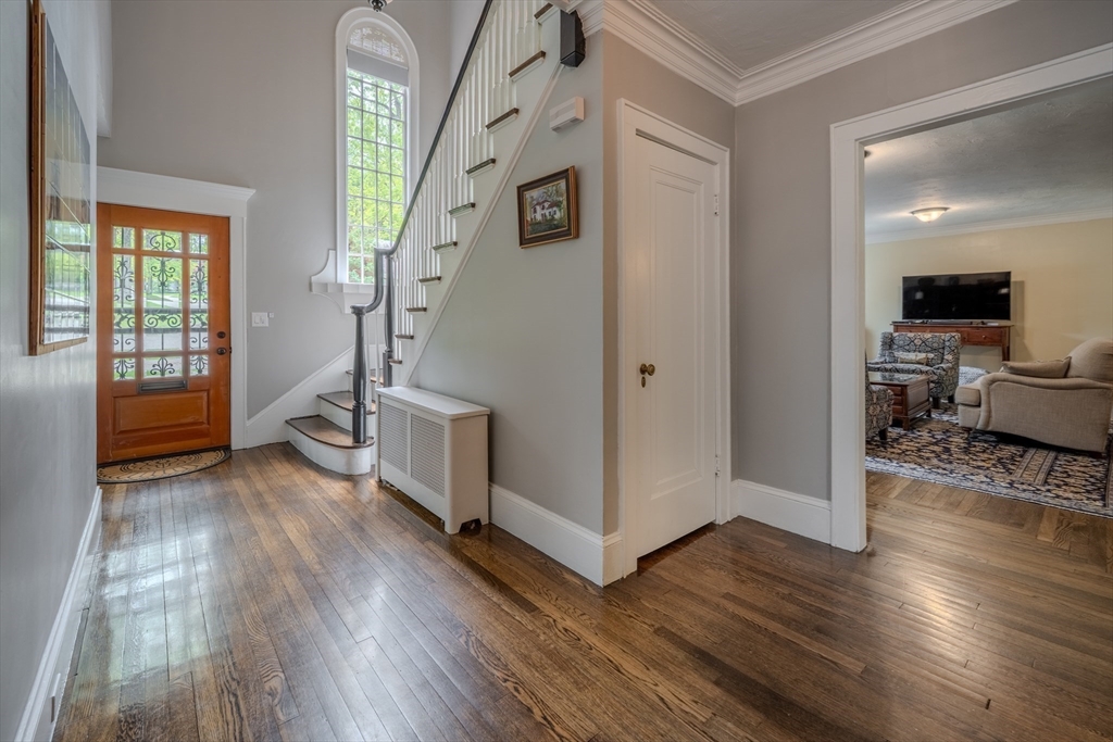 7 Argyle Street Worcester, MA 01609 - Photo 4 of 41 a view of a hallway with wooden floor and livingroom with furniture