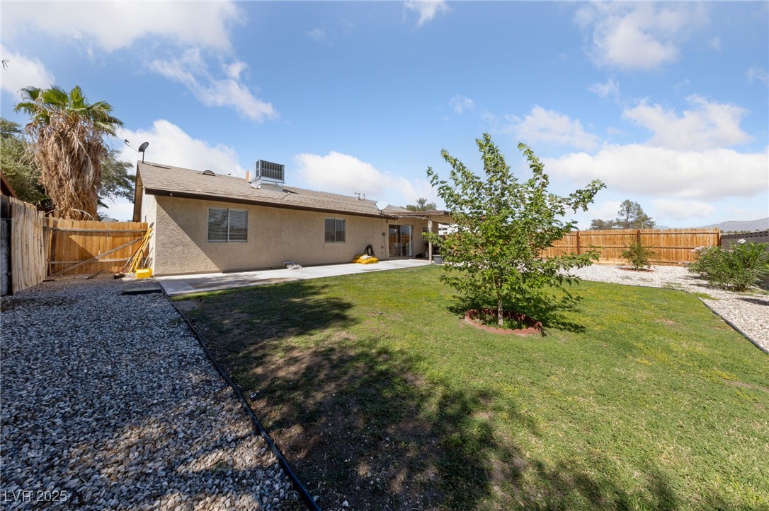 2637 Rialto Road Las Vegas, NV 89108 - Photo 22 of 22 Back of house with a patio, stucco siding, a lawn, cooling unit, and a fenced backyard