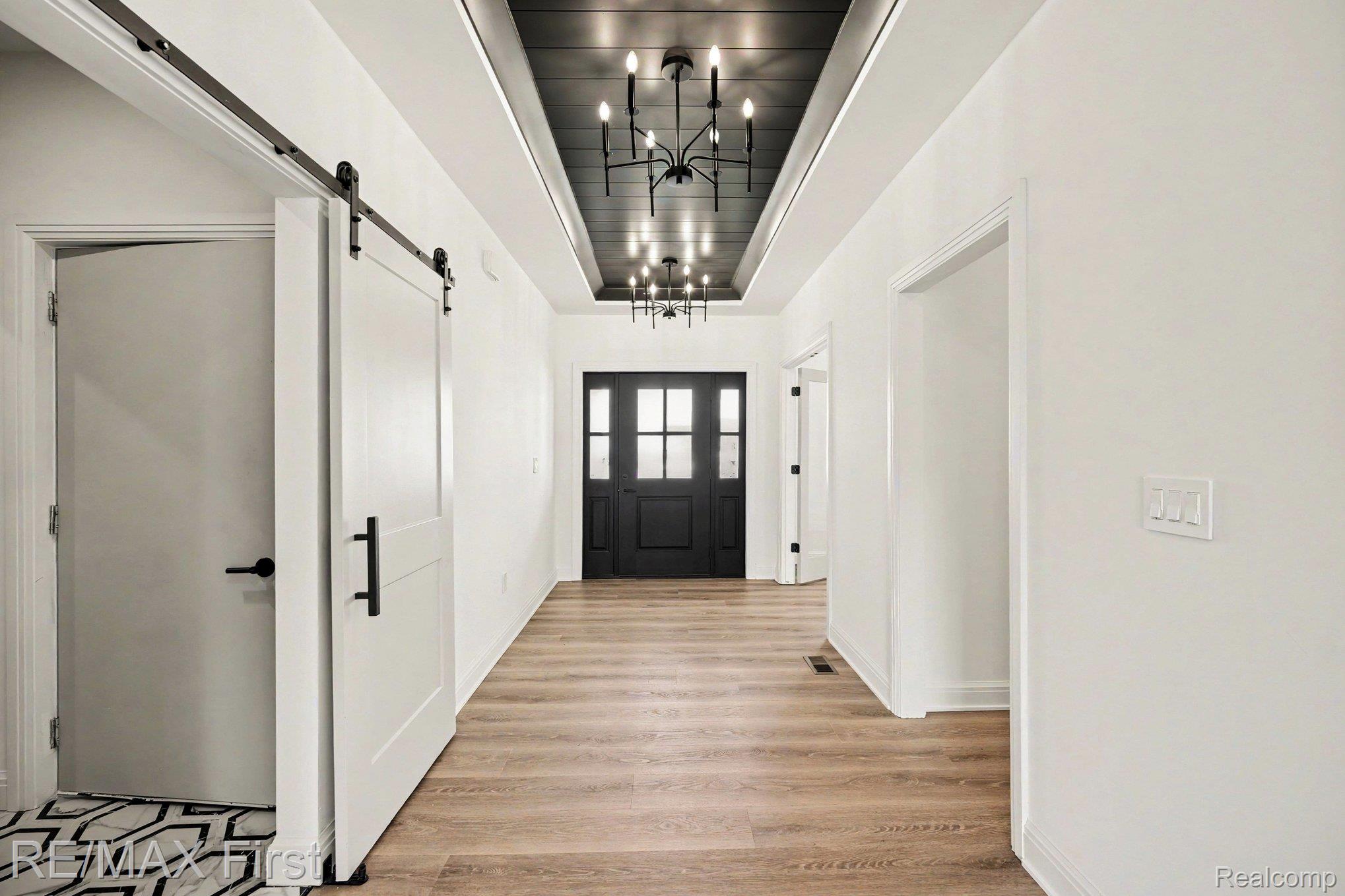 7424 Dyke Road Algonac, MI 48001 - Photo 10 of 31 Entryway with a barn door, suspended lighting, and light wood-style floors