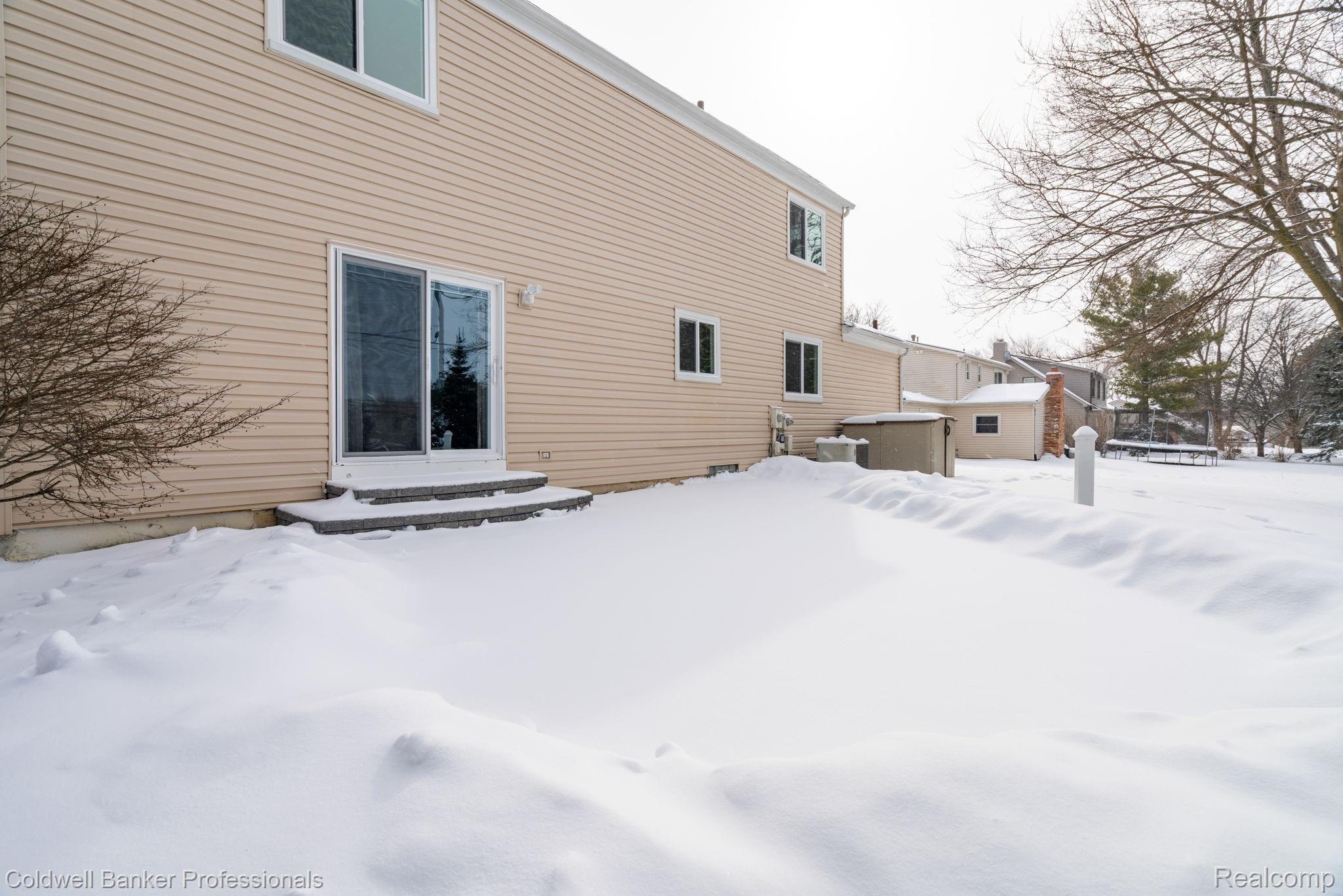 916 Dickson Lane Rochester, MI 48307 - Photo 28 of 30 Underneath that snow is a beautiful brick paver patio