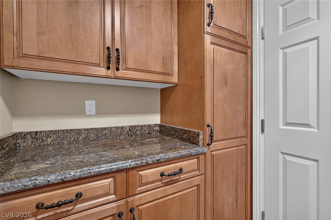 818 Manor Shores Road Henderson, NV 89002 - Photo 27 of 35 Premium granite counters and ample custom cabinetry provide exceptional storage and style in this utility space.
