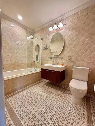 a bathroom with a sink mirror vanity and a toilet