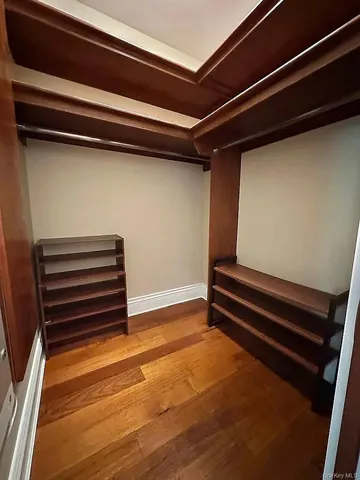 a view of room with stairs and a wooden floor