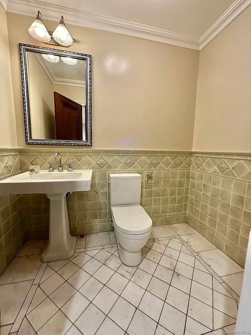 190 Saint Marks Avenue Brooklyn, NY 11238 - Photo 8 of 8 a bathroom with a toilet a sink and mirror