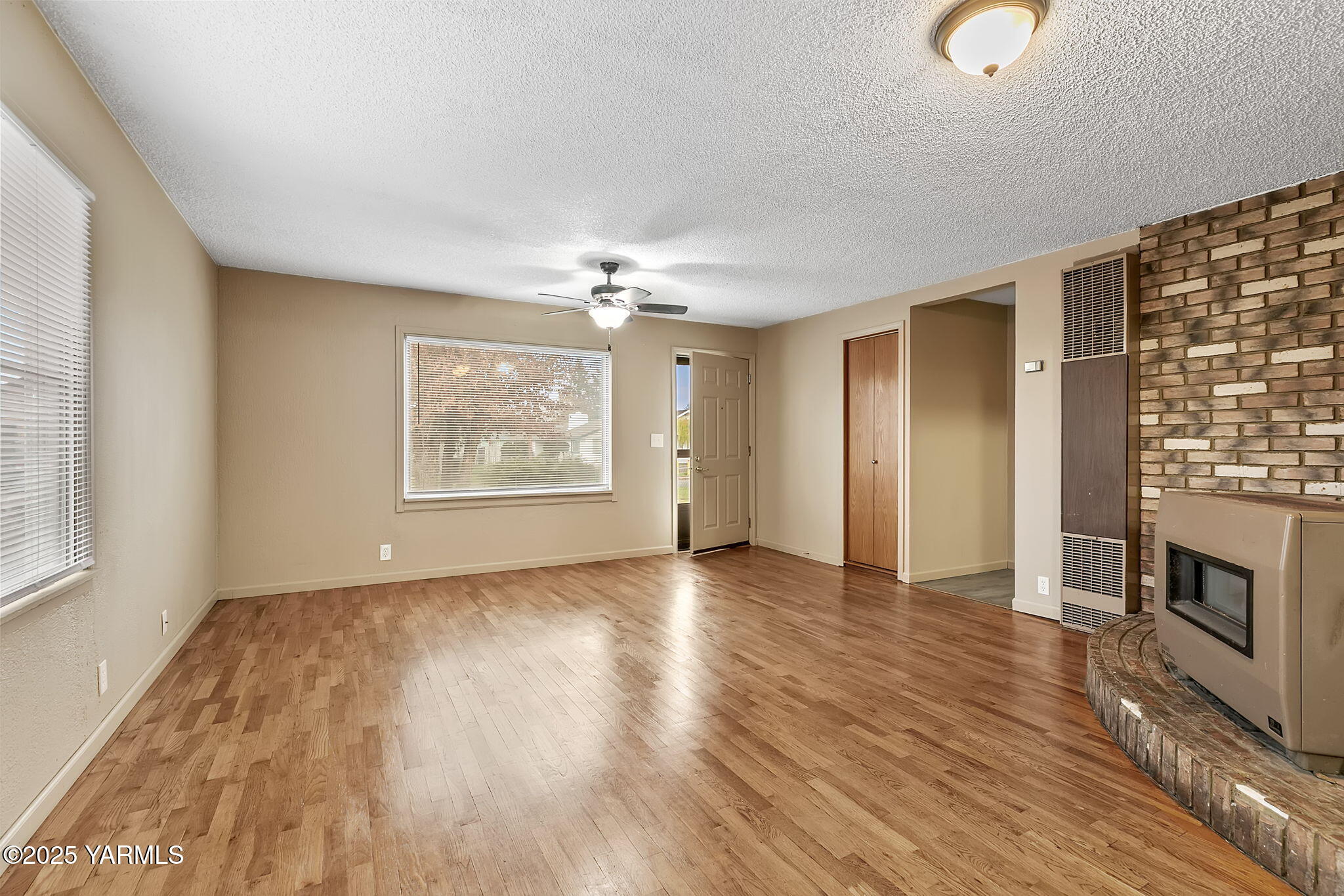 503 North Chestnut Street Toppenish, WA 98948 - Photo 3 of 21 wooden floor in an empty room with a window