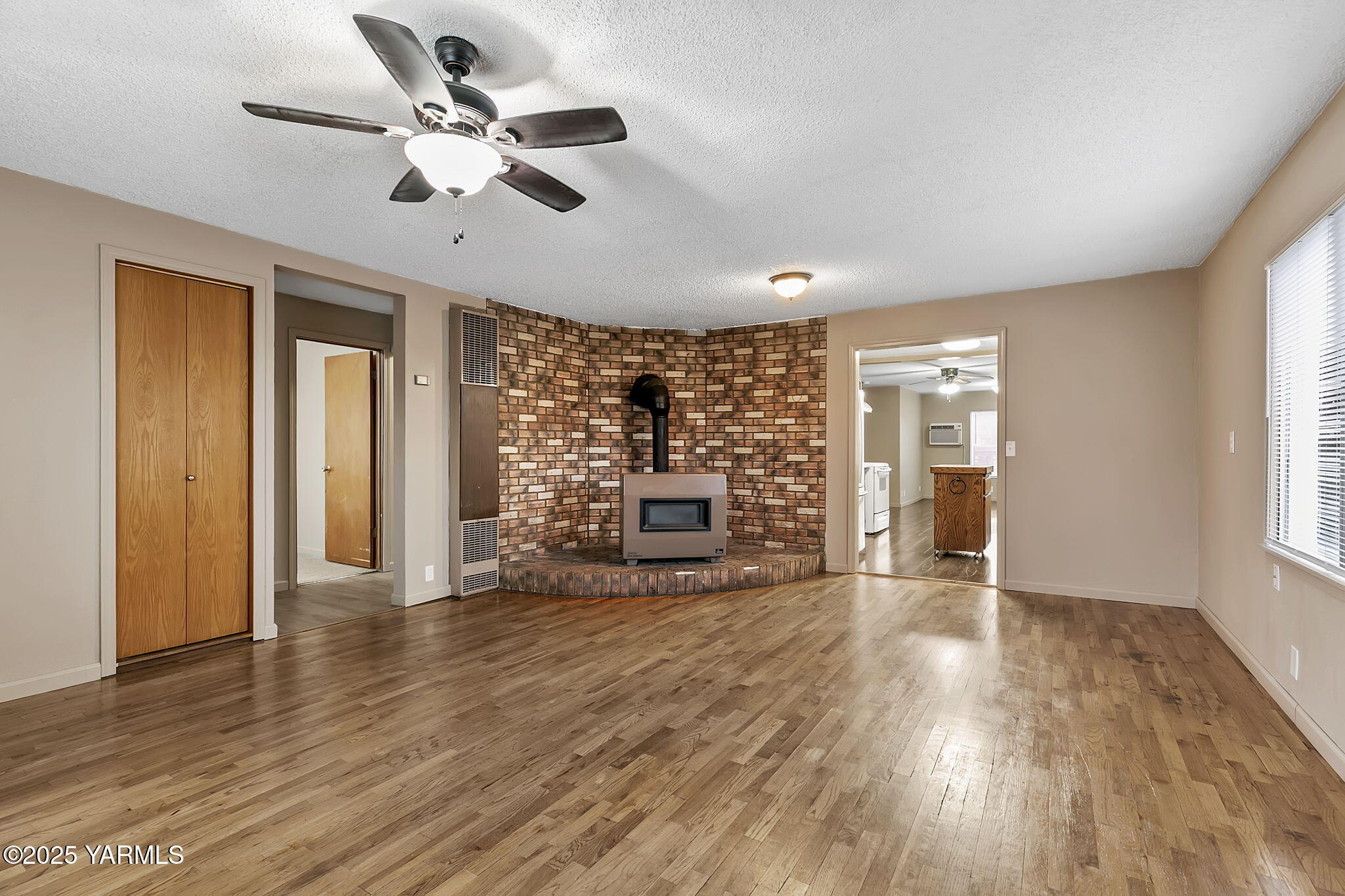 503 North Chestnut Street Toppenish, WA 98948 - Photo 5 of 21 a view of an empty room with a window and wooden floor