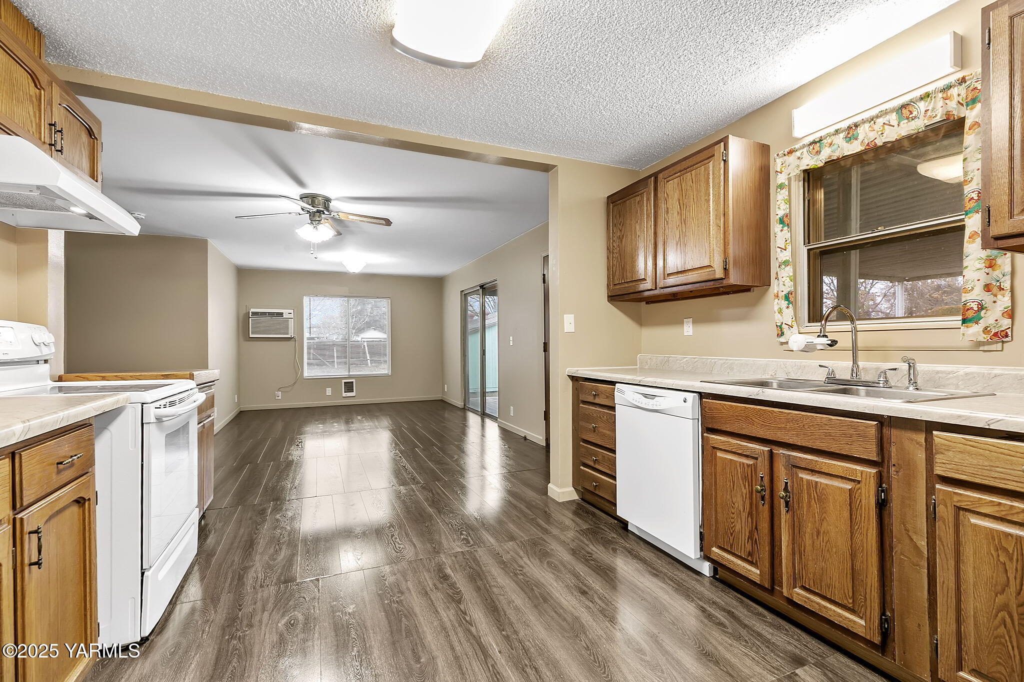 503 North Chestnut Street Toppenish, WA 98948 - Photo 7 of 21 a view of a kitchen with a sink wooden cabinets and entryway