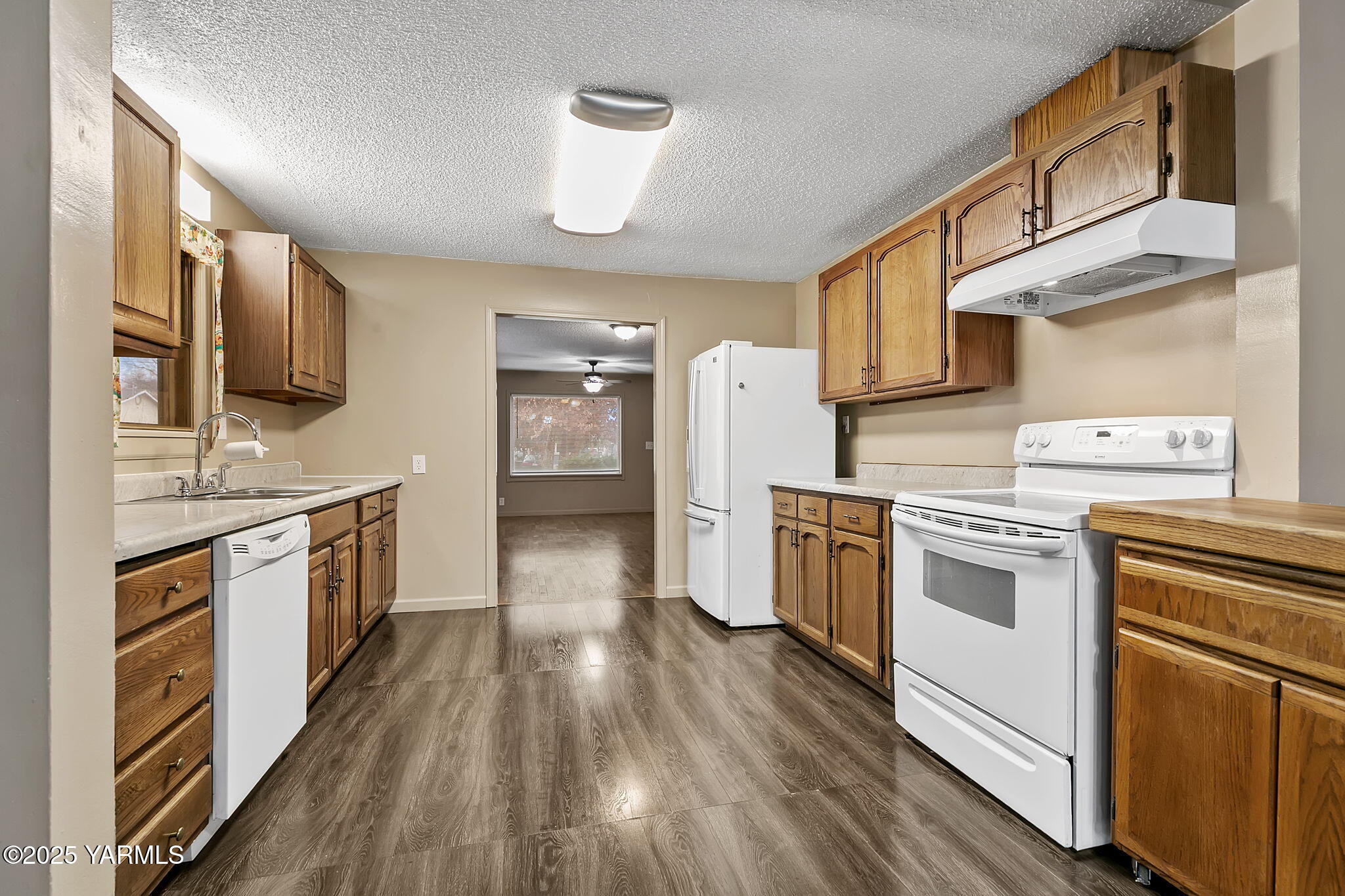 503 North Chestnut Street Toppenish, WA 98948 - Photo 8 of 21 a kitchen with stainless steel appliances a refrigerator a stove top oven and sink