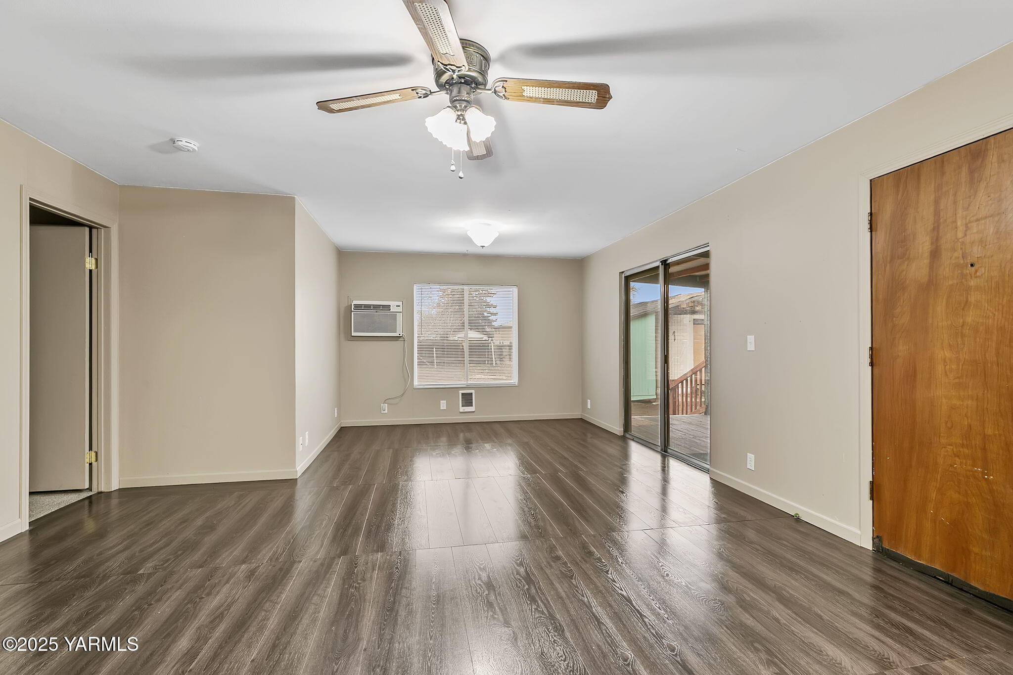 503 North Chestnut Street Toppenish, WA 98948 - Photo 9 of 21 an empty room with wooden floor chandelier fan and windows