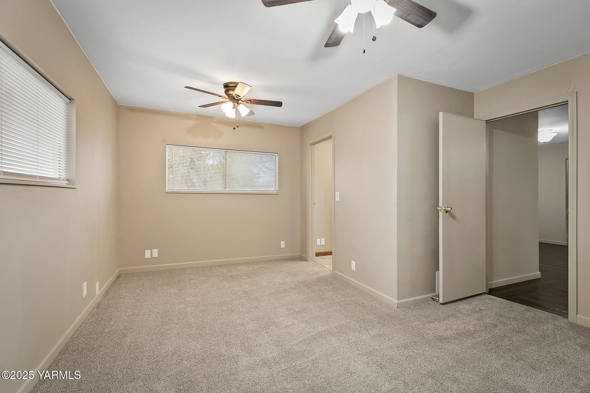 503 North Chestnut Street Toppenish, WA 98948 - Photo 10 of 21 a view of an empty room with a ceiling fan and a window