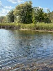 a view of a patio with table and chairs with wooden floor and fence