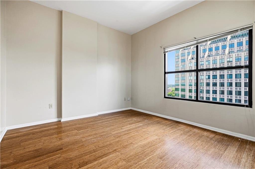 3040 Peachtree Road Northwest, Unit 1503 Atlanta, GA 30305 - Photo 14 of 38 wooden floor in an empty room with a window