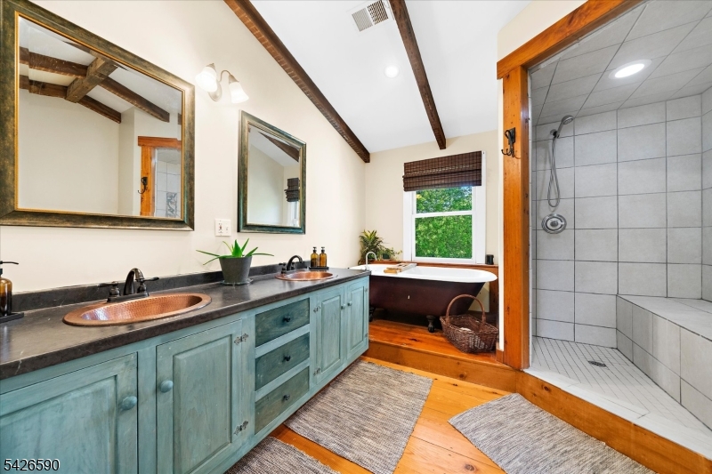 179 Lindbergh Road Hopewell, NJ 08525 - Photo 20 of 46 a bathroom with a sink a mirror and a bathtub