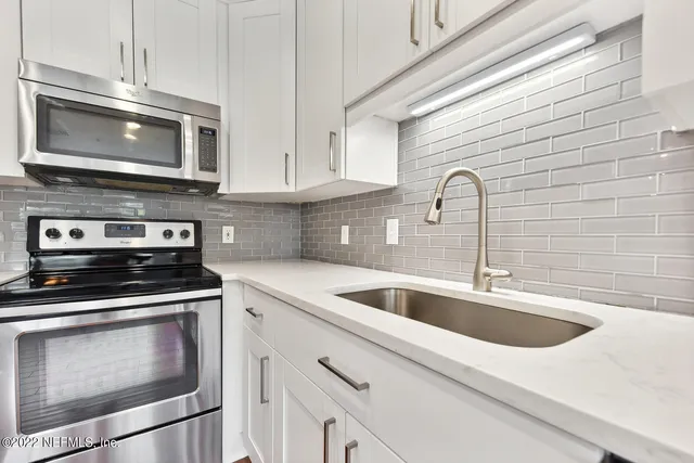 an entryway with wooden floor and cabinet